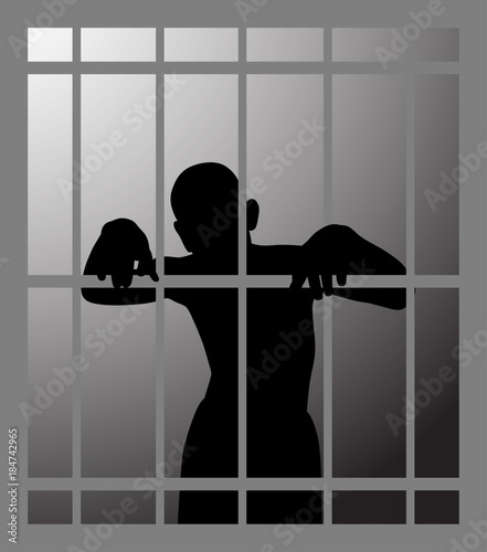 Man in prison or dark dungeon behind bars