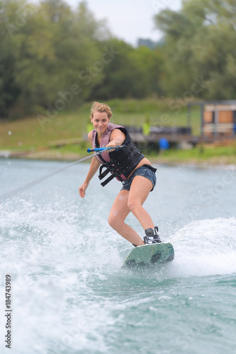 Fototapeta Naklejka Na Ścianę i Meble -  girl riding on wakeboarding