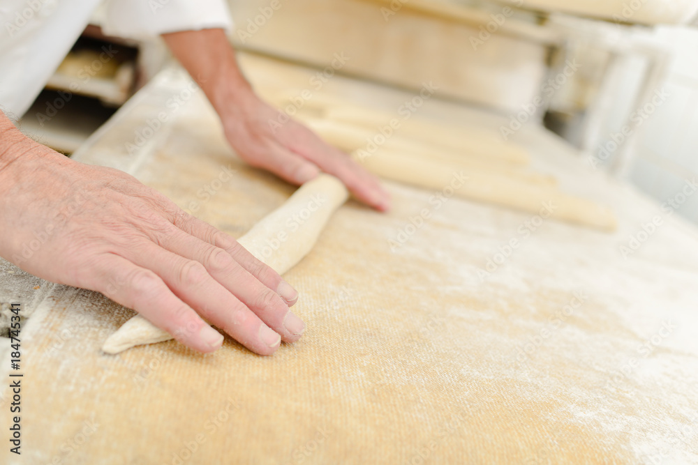 Rolling dough for baguettes Rolling dough for baguettes