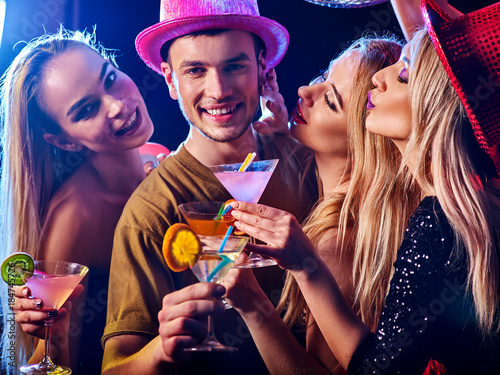 Dance party with group people dancing. How to be an alpha male at a club. Women and confident casual smiling man have fun in night club. Seduce boozy woman drink alcohol coktail and cuddles up guy .
