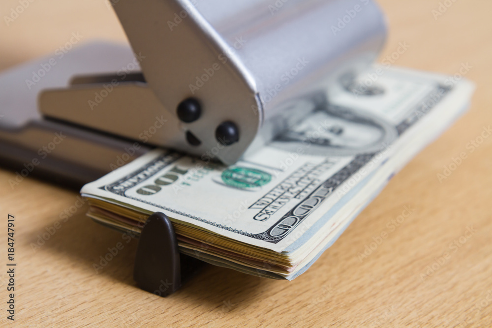 paper money closeup of the hole punch. business concept, unique image. interesting unusual image with dollars. viewed from the side paper money closeup of the hole punch. business concept, unique image. interesting unusual image with dollars. viewed from the side