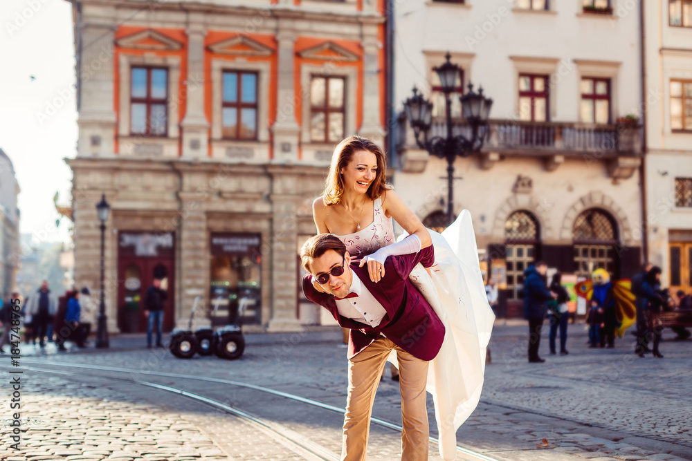 A young couple have fun in the heart of the historic city