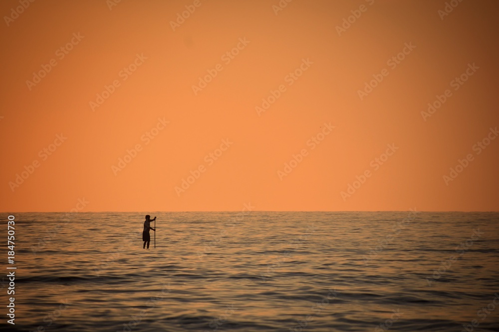 A man paddle boarding