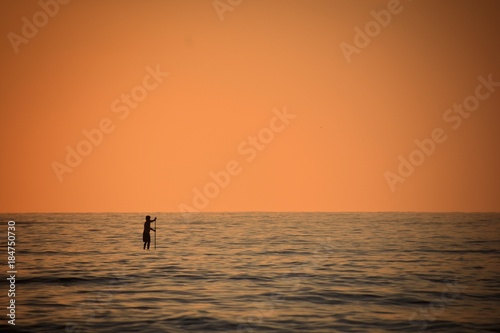 A man paddle boarding © Nicholas