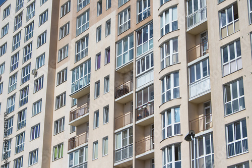 Many windows in the wall of the apartment house