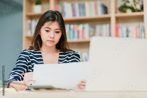 Startup business or student Asian woman working with laptop and document on the table