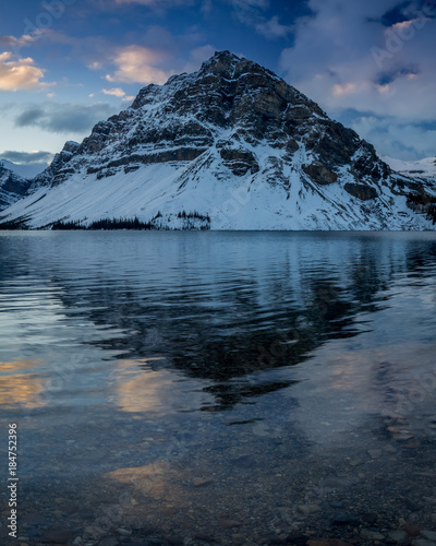 Canadian Rockies reflected in Bow Lake before sunrise in Banff National Park, Alberta