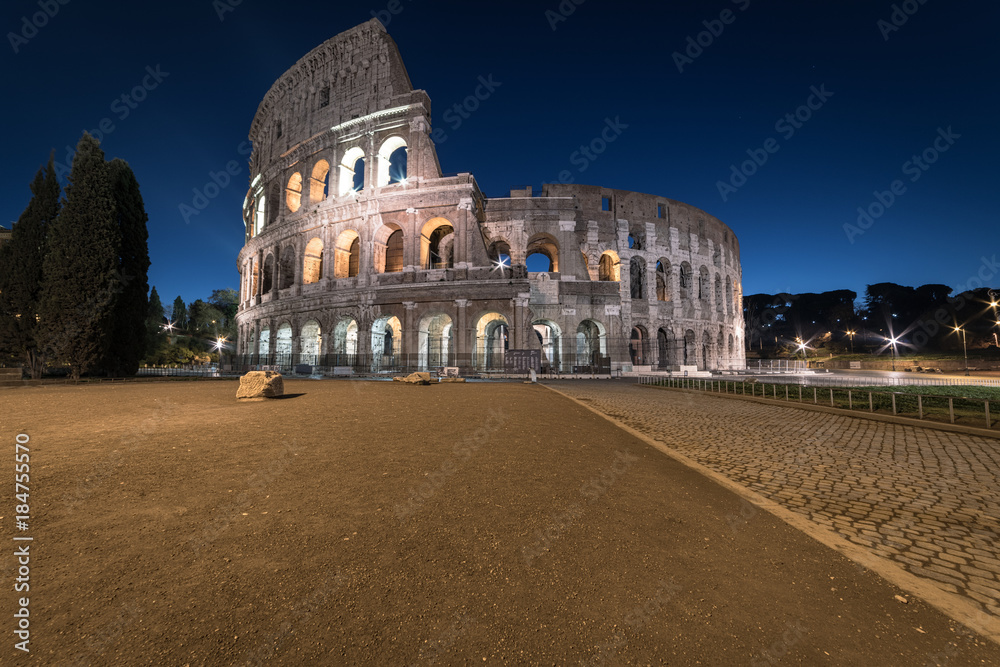 Colosseum at twilight, Rome, Italy, Europe. Ancient arena of gladiator fights. Colosseum is the most important landmark of Rome and Italy.