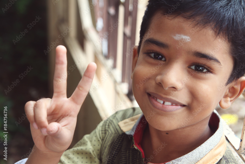 Portrait of Indian Boy showing victory or peace sign Portrait of Indian Boy showing victory or peace sign