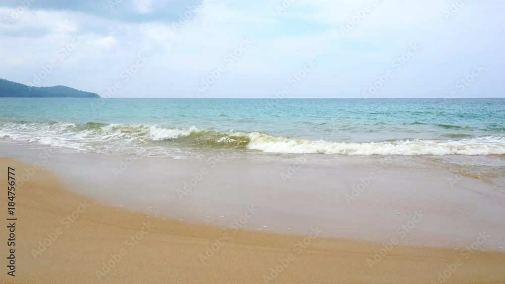 tropical andaman seascape scenic off mai khao beach phuket thailand with wave crashing on sandy shore tropical andaman seascape scenic off mai khao beach phuket thailand with wave crashing on sandy shore