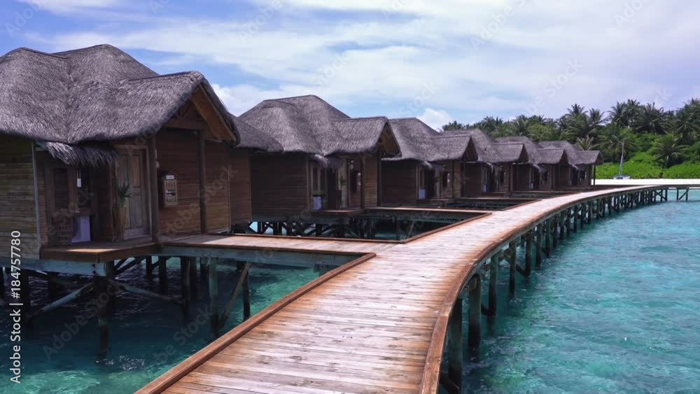 Tropical travel card with pristine beach and water bungalows at maldivian island