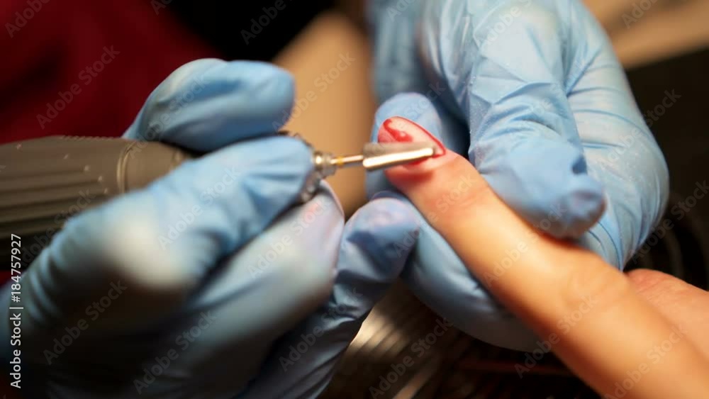 Receiving cuticle removing procedure with nail tools. Receiving cuticle removing procedure with nail tools.