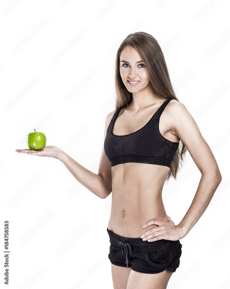 concept of a healthy lifestyle: portrait of a female fitness instructor with an Apple in his hand concept of a healthy lifestyle: portrait of a female fitness instructor with an Apple in his hand
