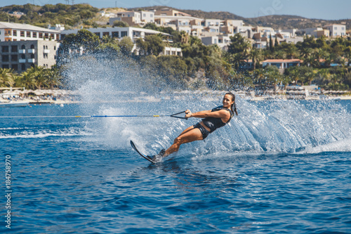 Water skis glides on the waves, female athlete on Aegean Sea,
