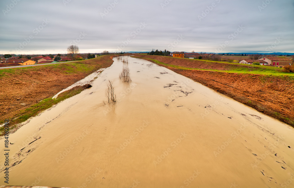 Muddy waters of a swollen river Muddy waters of a swollen river