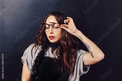 Portrait of seductive hipster girl wearing glasses