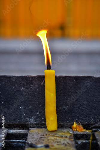 Bright candle in candle rack.