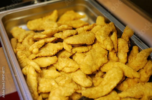 Fried chicken tenders in the stainless container