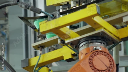 automatically applying hermetic on a car window, close-up of moving robot