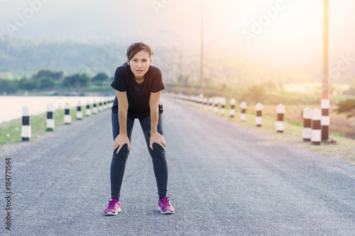 Athlete female stopped running to rest