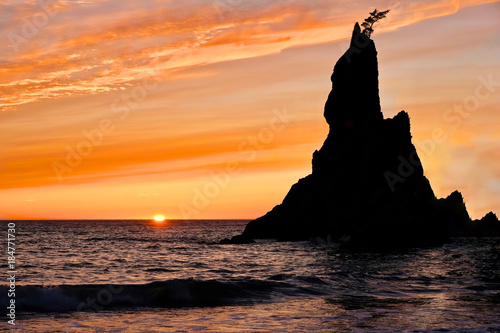 Sunset at Rialto Beach. Sea stack silhouette by sunset sky. Pacific Northwest. Olympic National Park on Olympic Penincula near Olympica and Port Angeles. Seattle. Washington. United States of America.