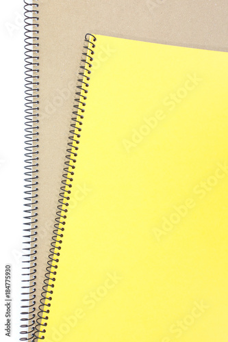 Yellow note book cover and brown note book on white background