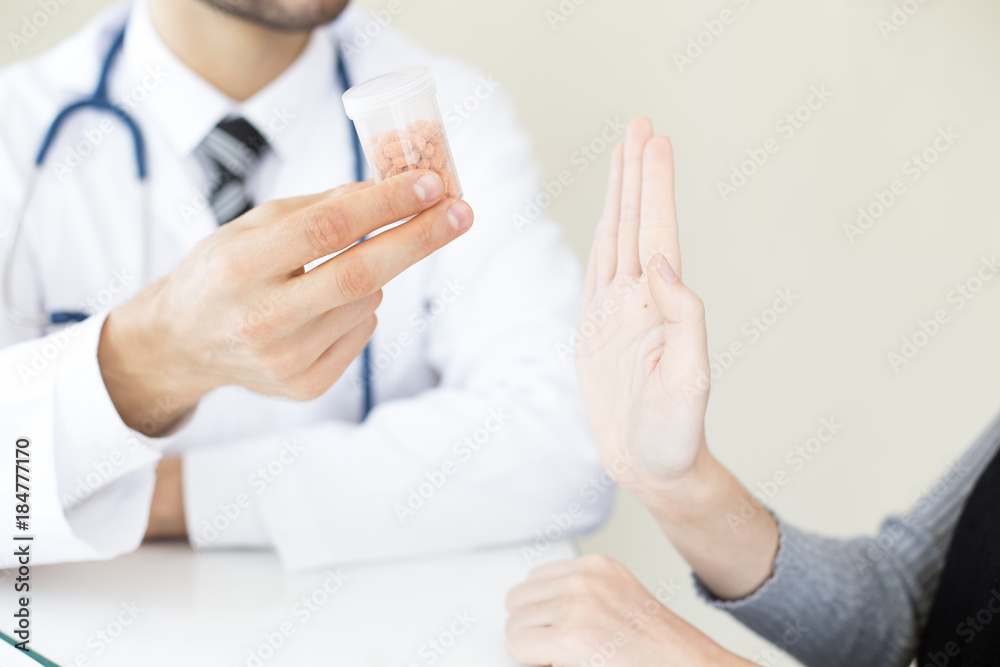 Hand of Doctor holding medicine showing to patient. People with medical concept. Hand of Doctor holding medicine showing to patient. People with medical concept.