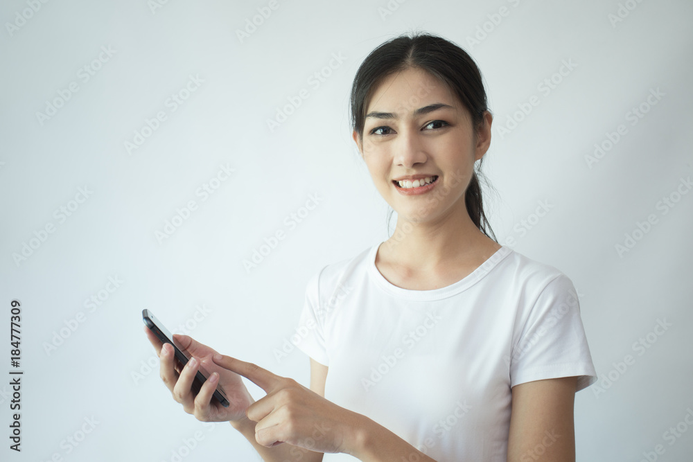 Portrait of Attractive Asian Woman using smartphone with smiling on white background. Portrait of Attractive Asian Woman using smartphone with smiling on white background.