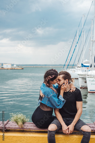 Guy and girl on pier © teksomolika