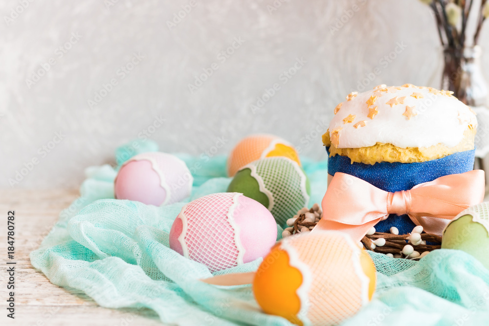 Easter cake with white icing and Easter eggs on a light background Easter cake with white icing and Easter eggs on a light background