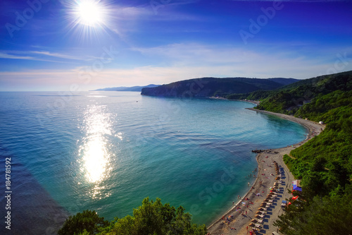 Bright sun over the beach and sea. Russia , Bukhta Inal.