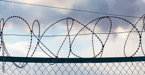 Fence with barbed wire as a background