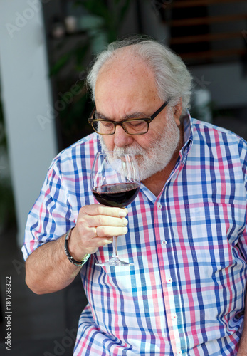 Mature man drinking wine