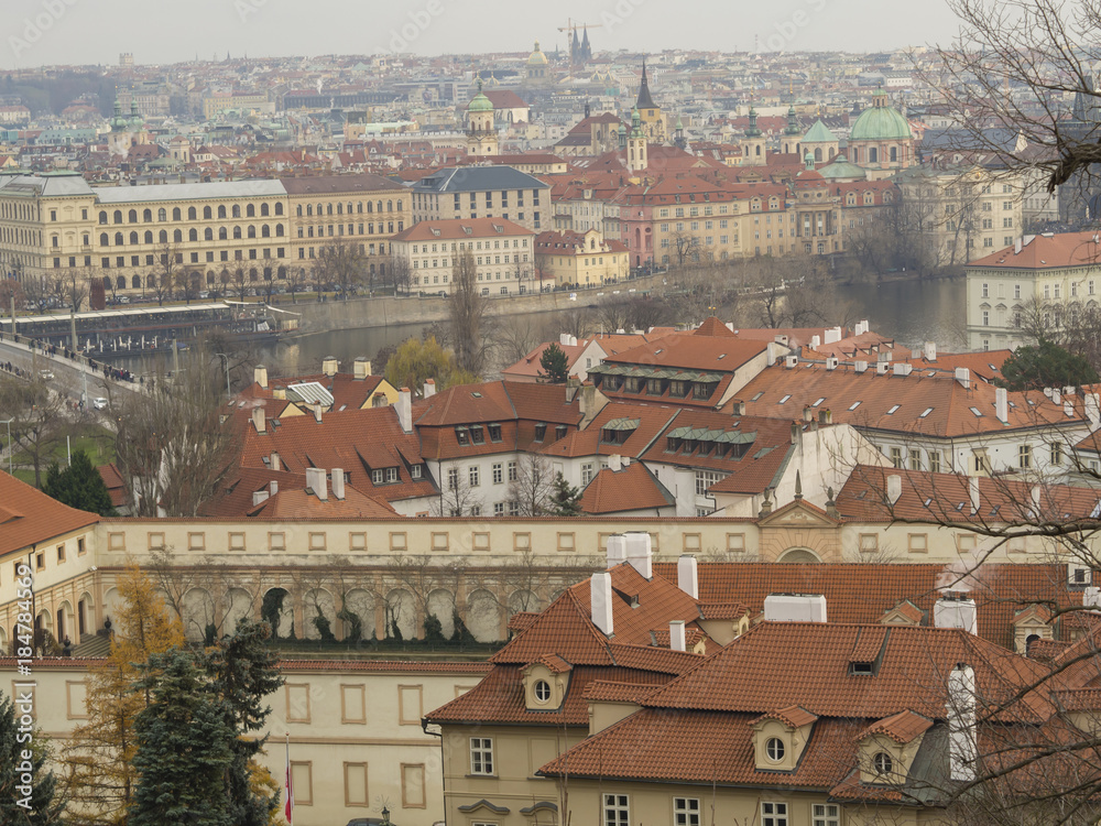 Prague city panorama View on old town with teen saint nicholas church palaces and vltava river bank from old castle steps way to prague castle in winter evening