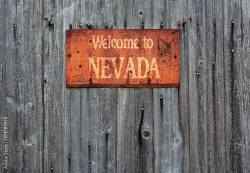 Rusty metal sign with the phrase: Welcome to Nevada.