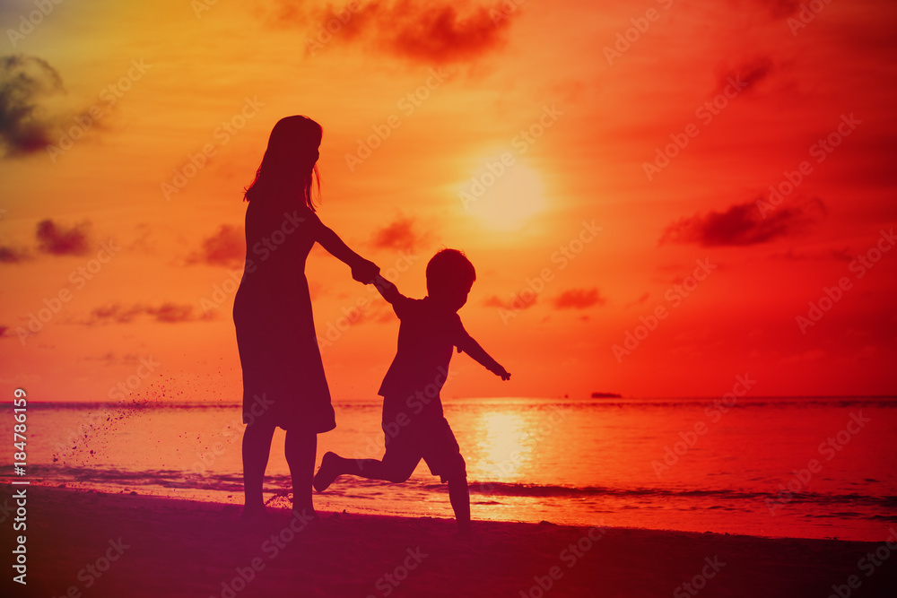mother and son play have fun on sunset