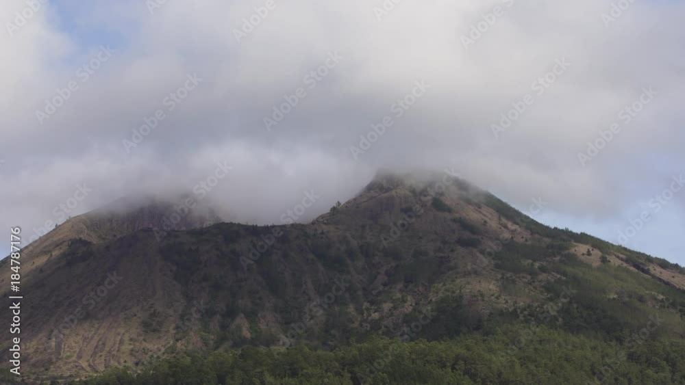 Volcano, mountain covered forest, sky with clouds, traces of lava on the ground. Mount Batur Volcano in Kintamani. Mountain landscape, Bali. 4K video. Travel concept. Volcano, mountain covered forest, sky with clouds, traces of lava on the ground. Mount Batur Volcano in Kintamani. Mountain landscape, Bali. 4K video. Travel concept.