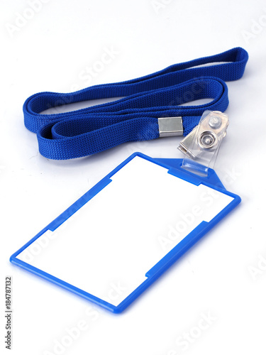 Blank fold and clip name tag or identification badge on blue woven lanyard strap.