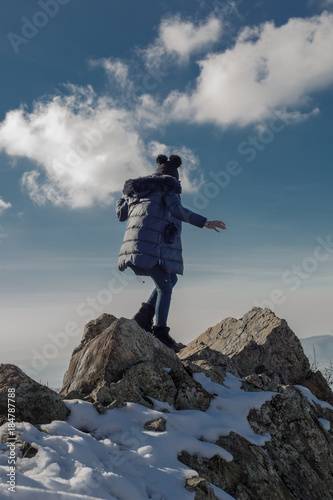 Young beautiful woman posing on cliff