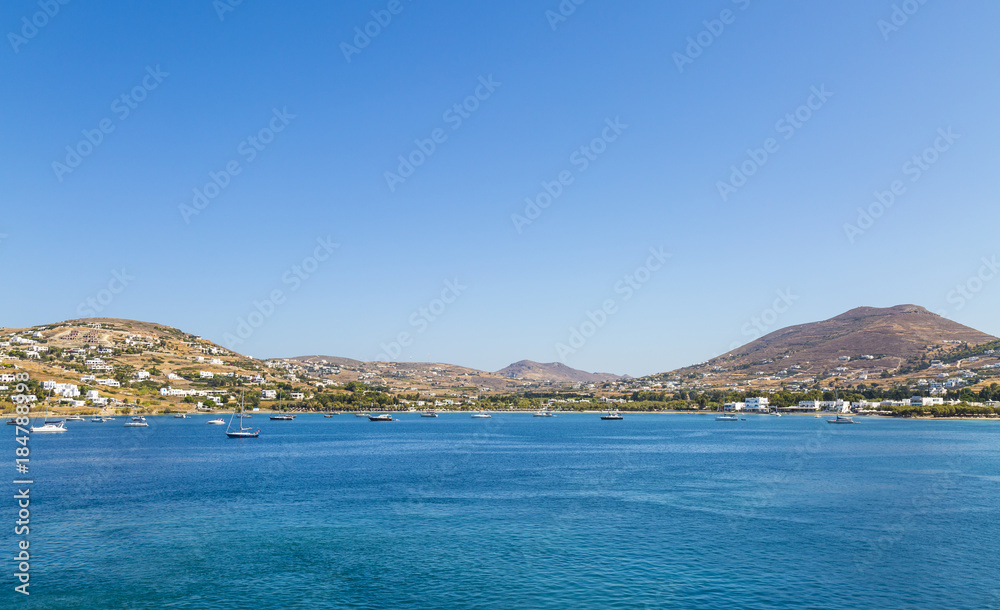 Greece. Cyclades. Paros island. Picturesque white houses near Parikia town. Yachts in the sea