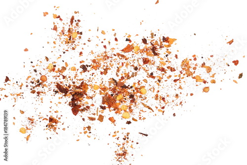 pile crushed red cayenne pepper, dried chili flakes and seeds isolated on white background, top view