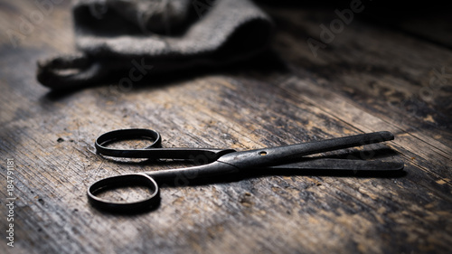 Old rusty scissors on wooden table