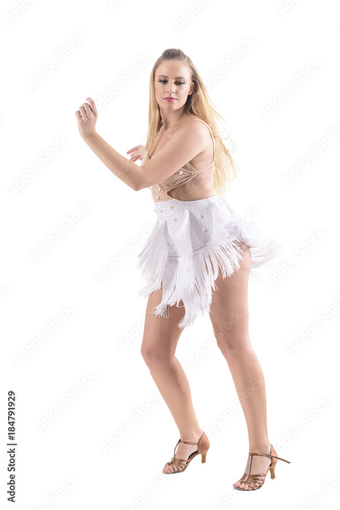 Naklejka premium Caucasian blonde woman professional dancer of latino dances wearing flowing fringed costume. Full body length portrait isolated on white background. 