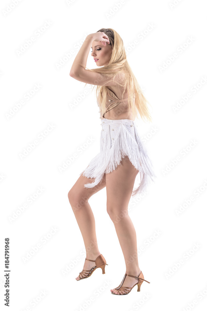 Blonde caucasian woman dancing latino dances in professional costume. Side view. Full body length portrait isolated on white background. 