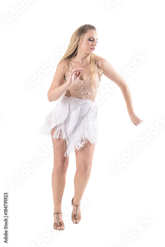 Confident professional woman dancer dancing latino style in cream color costume with fringes. Full body length portrait isolated on white background. 