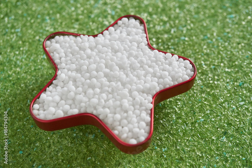  urea fertilizer in star shape on green magnesium fertilizer background.