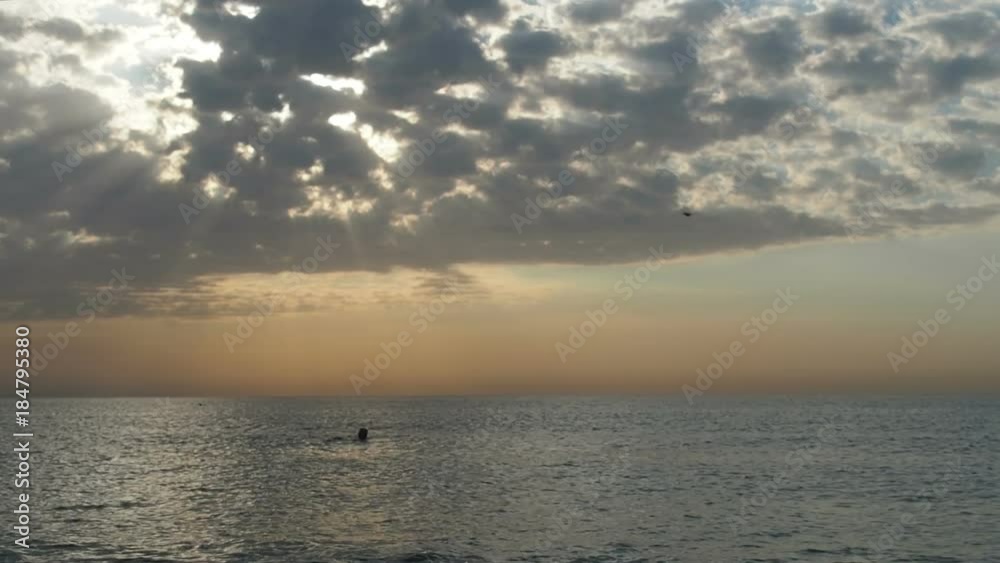 The sun is shining through the clouds. Sun rays through the clouds. The sun is shining through the clouds. Sun rays through the clouds.