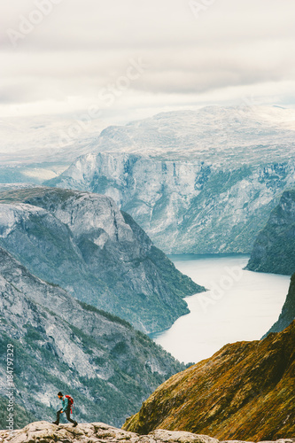 Man running at Naeroyfjord mountains landscape aerial view Travel Lifestyle concept adventure active vacations outdoor hiking sport in Norway scale showing