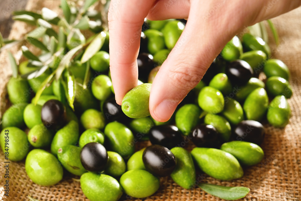 Genuine Italian organic oil cold pressed in slow motion falls on organic bread. concept of nature and healthy food, healthy and natural. fresh olives and Tuscan Italian oil Genuine Italian organic oil cold pressed in slow motion falls on organic bread. concept of nature and healthy food, healthy and natural. fresh olives and Tuscan Italian oil