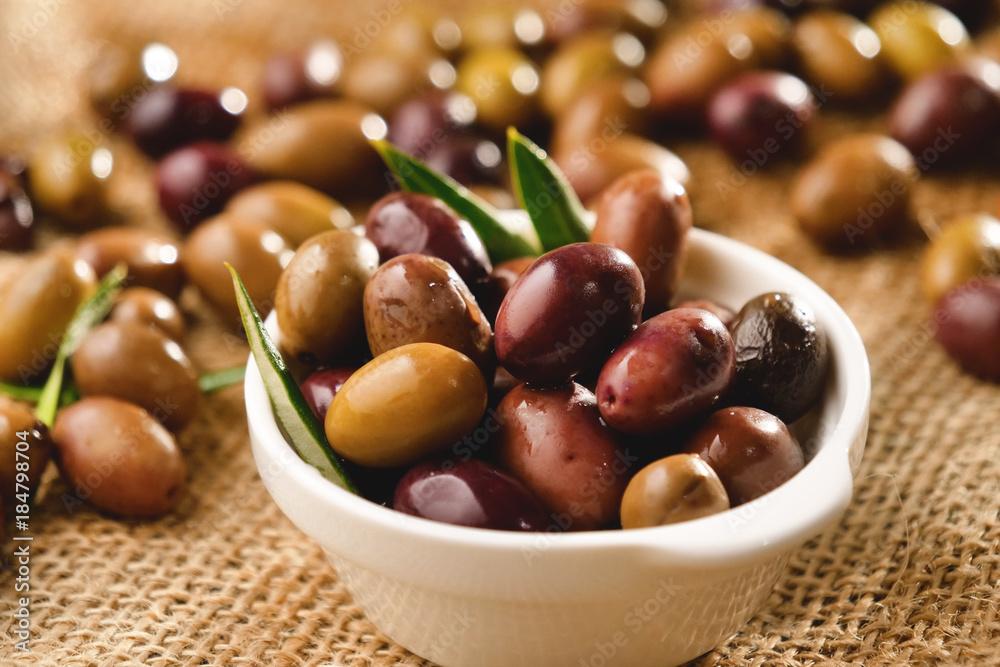Genuine Italian organic oil cold pressed in slow motion falls on organic bread. concept of nature and healthy food, healthy and natural. fresh olives and Tuscan Italian oil Genuine Italian organic oil cold pressed in slow motion falls on organic bread. concept of nature and healthy food, healthy and natural. fresh olives and Tuscan Italian oil